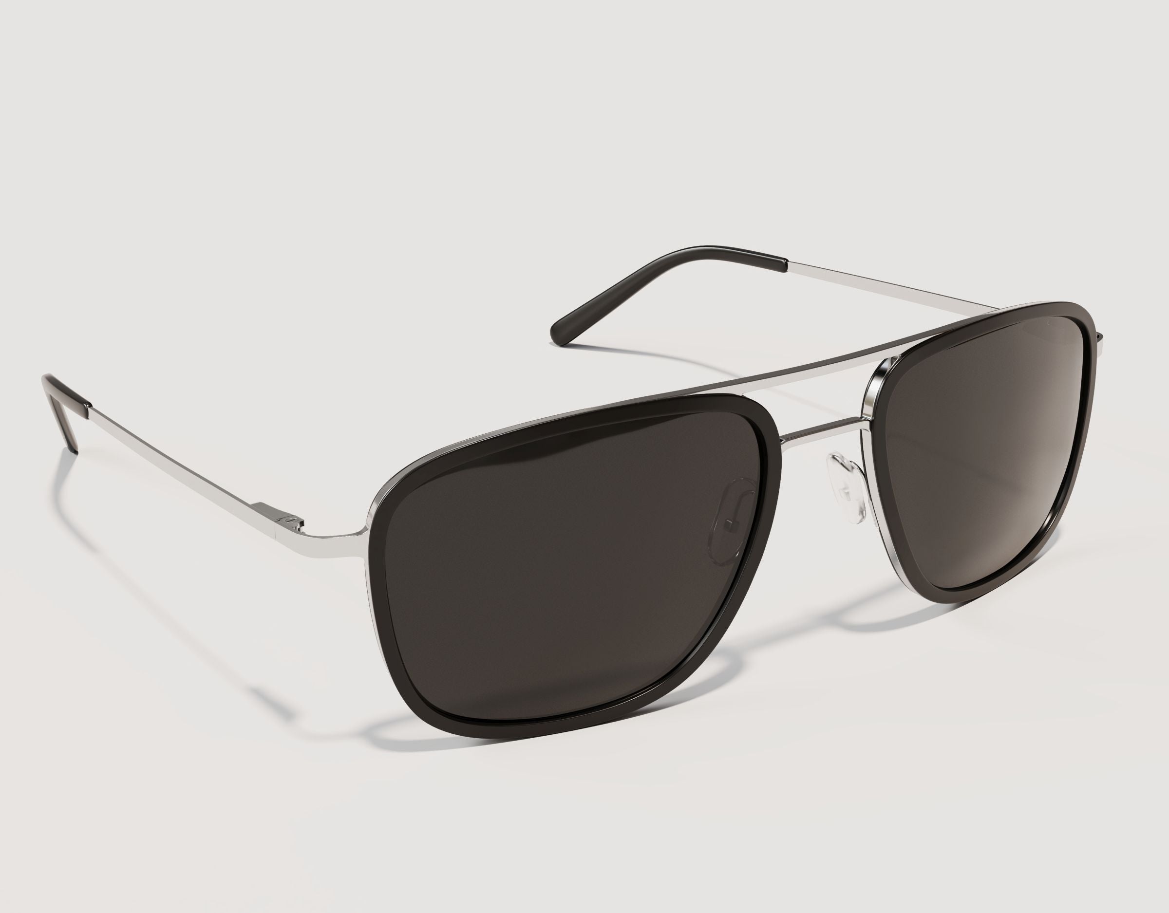 Side profile of The Arrival 155mm XL aviator-style sunglasses in Black and Chrome showing lightweight hybrid construction and spring hinges.