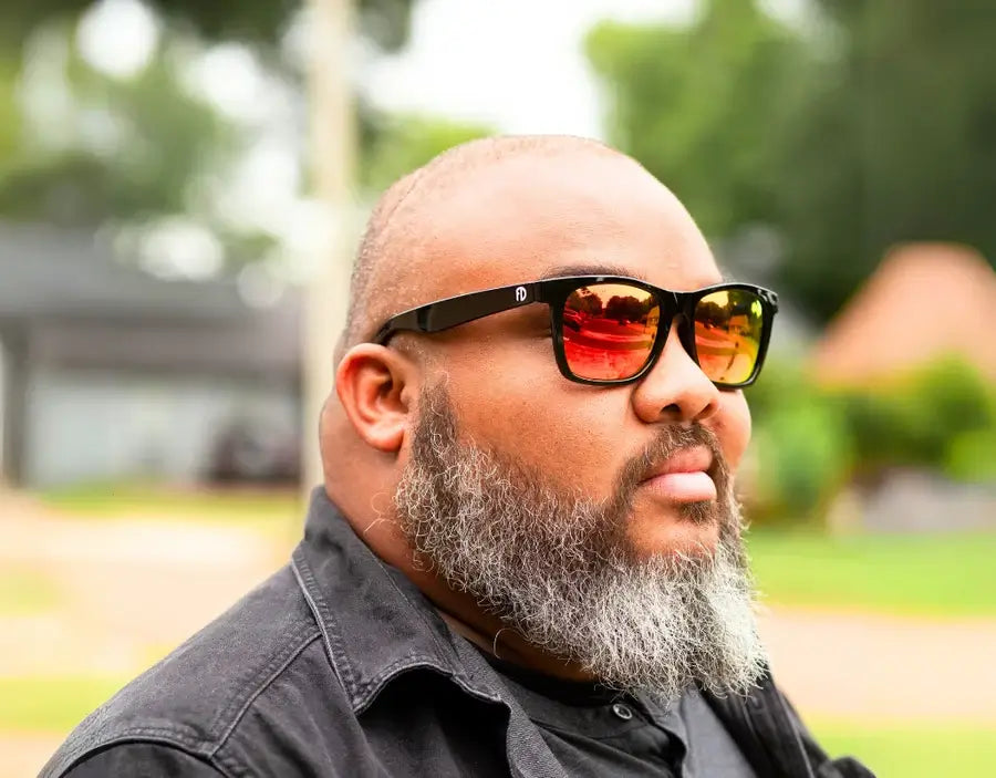 Model wearing Classic 165mm XXL polarised sunglasses in Black Gloss with yellow solar lenses – bold lens tone for wide faces.
