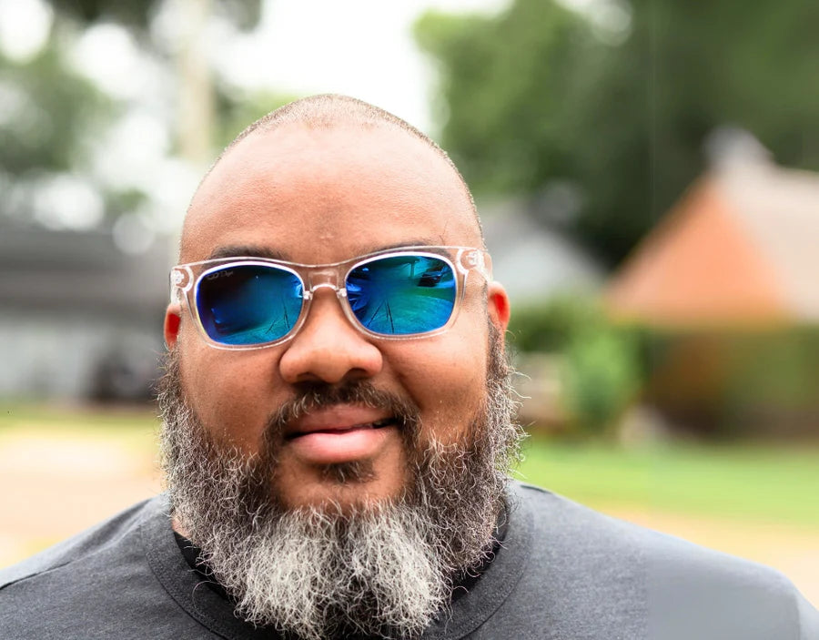 Model wearing The Gent 165mm XXL polarised sunglasses in Clear with blue ice lenses – oversized fit and modern edge.