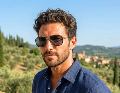 Model wearing The Arrival 155mm XL sunglasses in Black and Chrome with black smoke polarised lenses – modern aviator-style fit designed for larger heads.