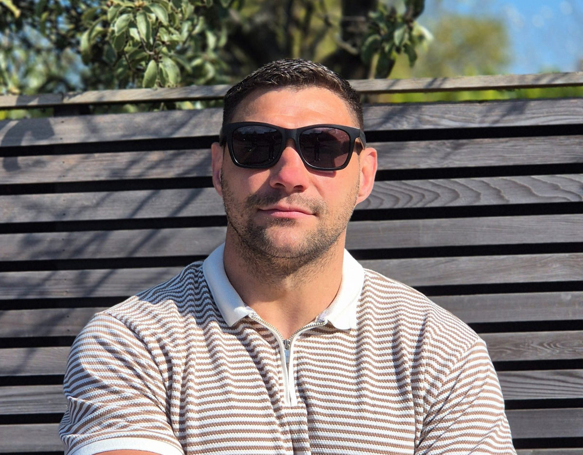 Model wearing Classic 155mm XL polarised sunglasses in Black Gloss – large head sunglasses with a secure and stylish fit.
