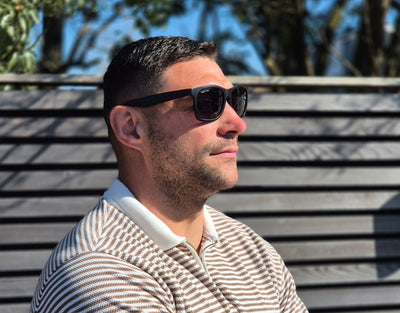 Model wearing Classic 155mm XL blackout polarised sunglasses – extra wide fit and bold, blacked-out style.