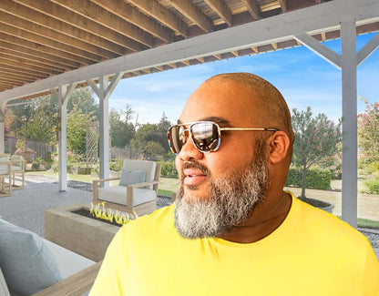 Model wearing The Arrival 165mm XXL big head sunglasses in Atlantic with brown polarised lenses – modern aviator-style design for wide faces.