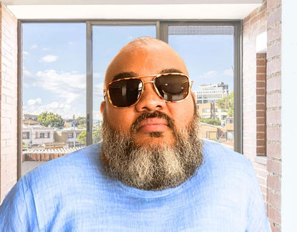 Model wearing The Arrival 165mm XXL big head sunglasses in Tortoise with brown polarised lenses – modern aviator-style design built for wide faces.