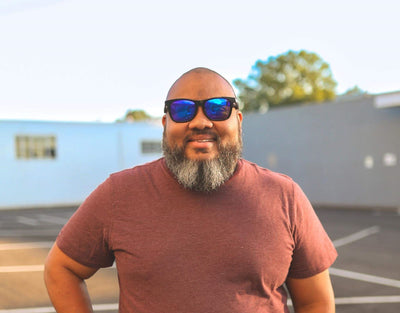 Model wearing Classic 165mm XXL large head sunglasses in Black Gloss with blue ice lenses – polarised and bold for wide faces.