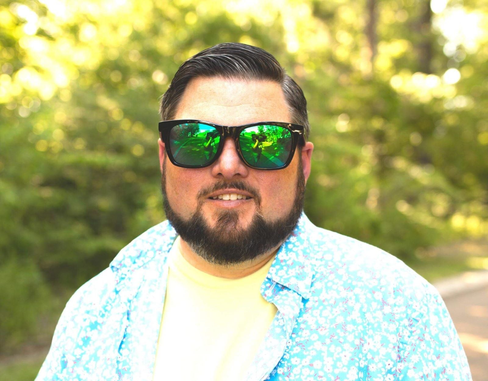 Model wearing Classic 165mm XXL polarised sunglasses for big heads in Black– large fit and bright lens colour combo.