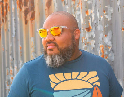 Model wearing Classic 165mm XXL polarised sunglasses in Clear with yellow solar lenses – bold wide-fit style for sunny days.