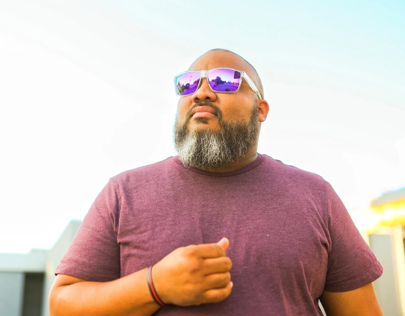 Model wearing Sport 165mm XXL polarised sport sunglasses in Clear with purple lenses – modern oversized frame for big heads.